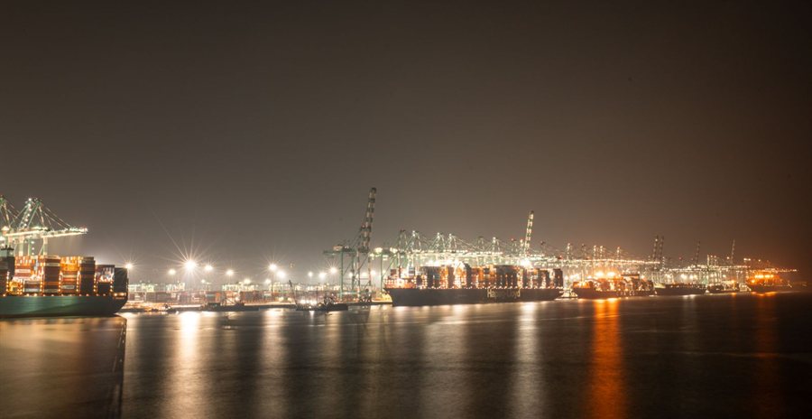 Container port at night with ships loading at the quay