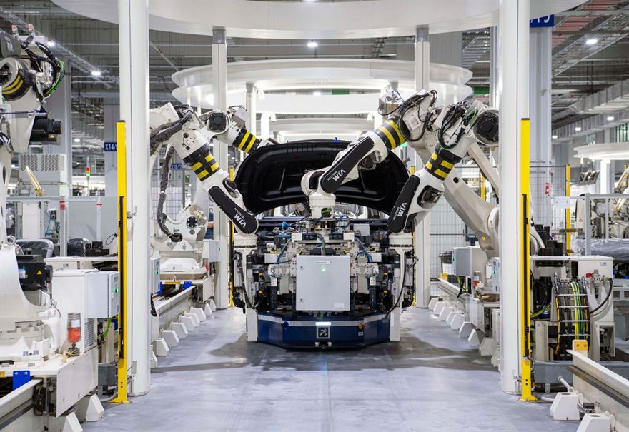 Vehicle body carried on an automated guided vehicle through a robotic assembly line