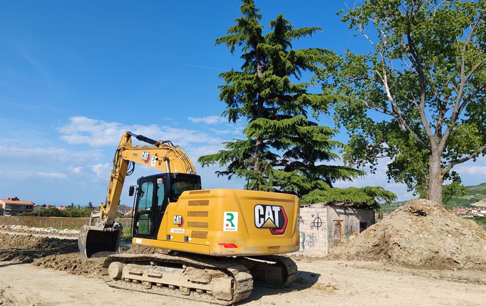 Tracked excavator working an earthmoving site